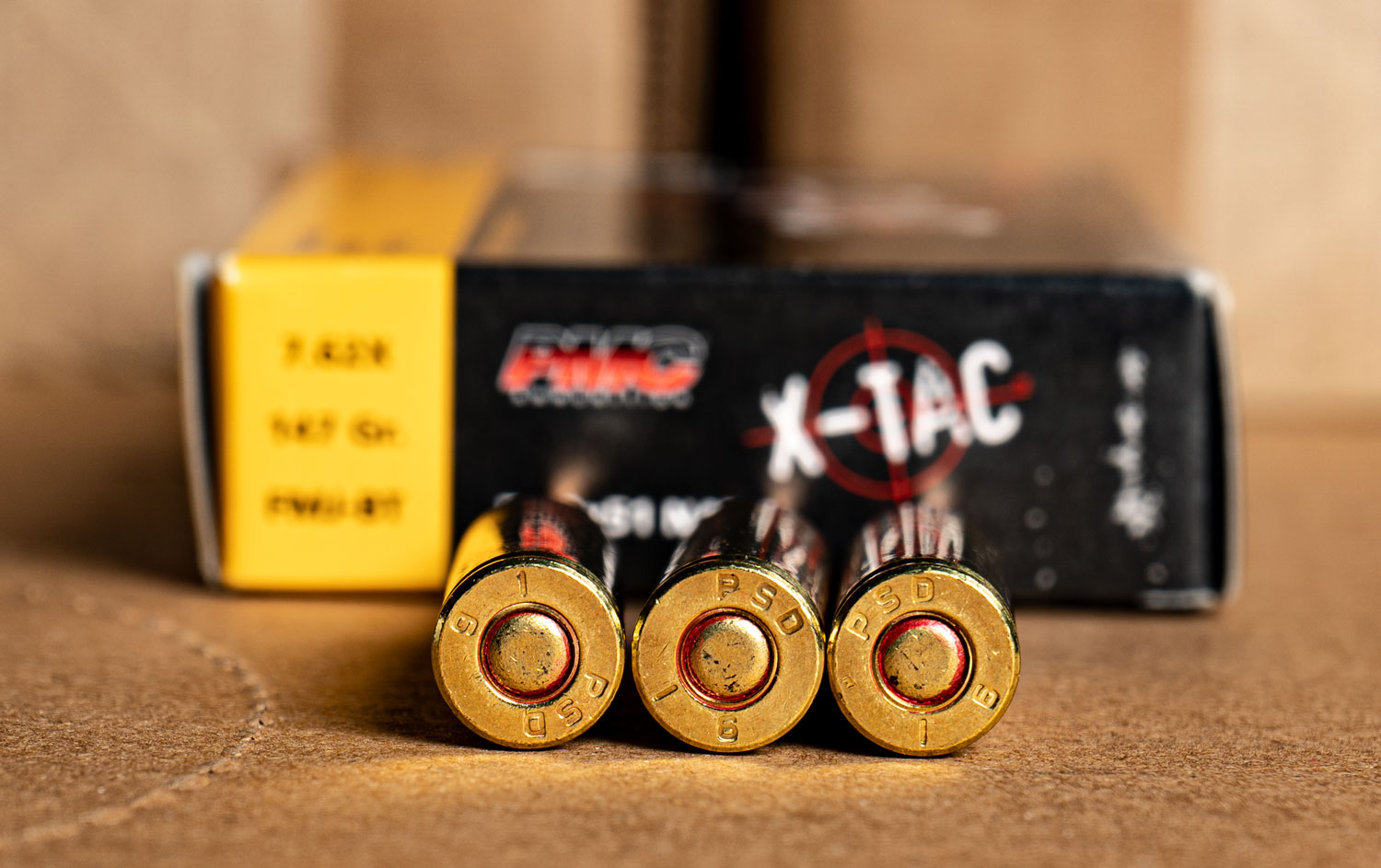 PMC X-TAC rifle ammo box with cartridges on a table