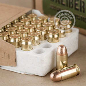 A photograph detailing the .45 Automatic ammo with FMJ bullets made by Winchester.