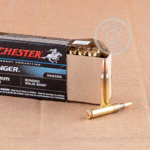 A photograph of 20 rounds of 64 grain 5.56x45mm ammo with a bonded solid brass bullet for sale.