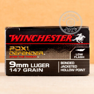 A photograph detailing the 9mm Luger ammo with JHP bullets made by Winchester.