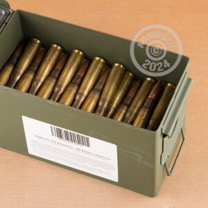 A photograph of 100 rounds of 660 grain .50 BMG ammo with a FMJ bullet for sale.