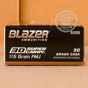 A photograph detailing the 30 Super Carry ammo with FMJ bullets made by Blazer Brass.
