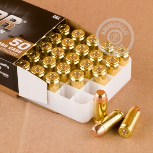 A photograph detailing the .40 Smith & Wesson ammo with Full Metal Jacket (FMJ) bullets made by Blazer Brass.